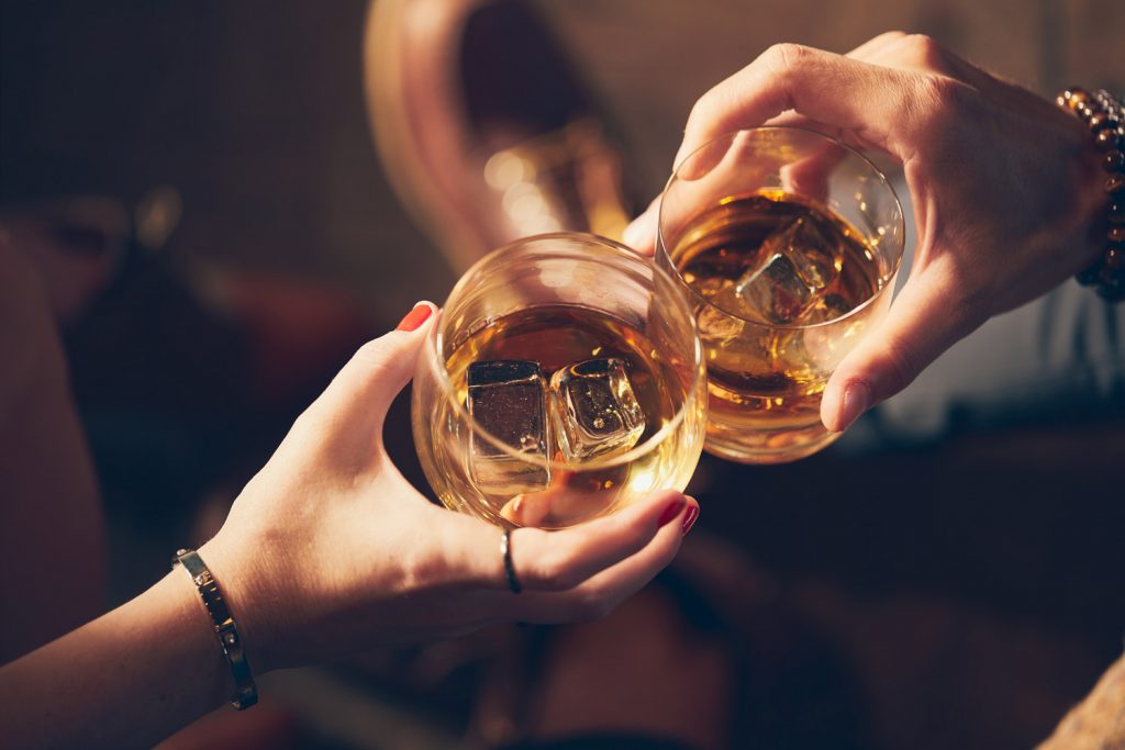 A couple enjoying a whisky tasting at a bar