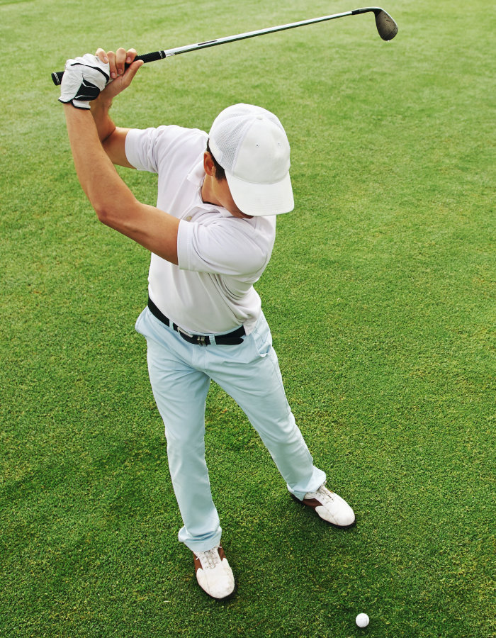 Overhead view of a golfer taking a swing