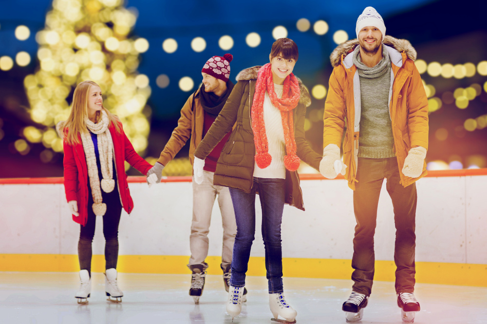 Adults skating on an outdoor ice rink