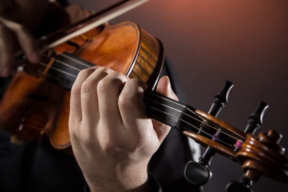 Close up of violin being played on stage